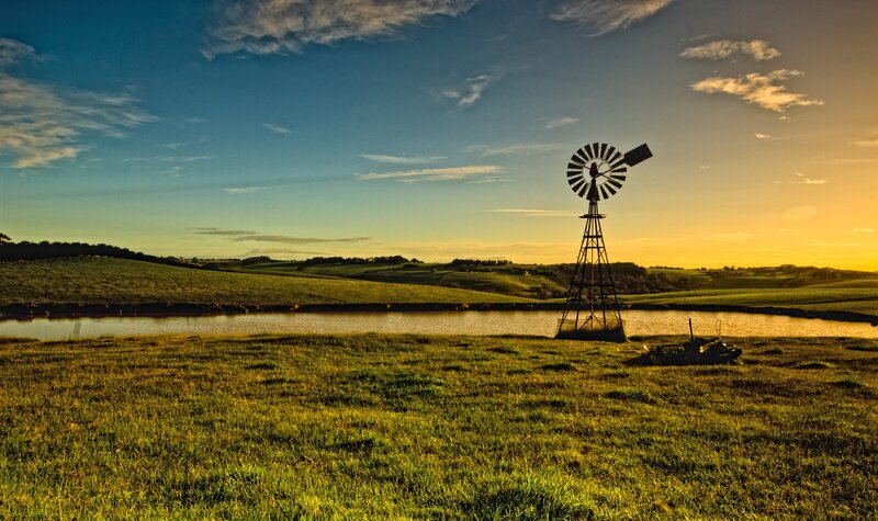 Windmill on Grassy Field