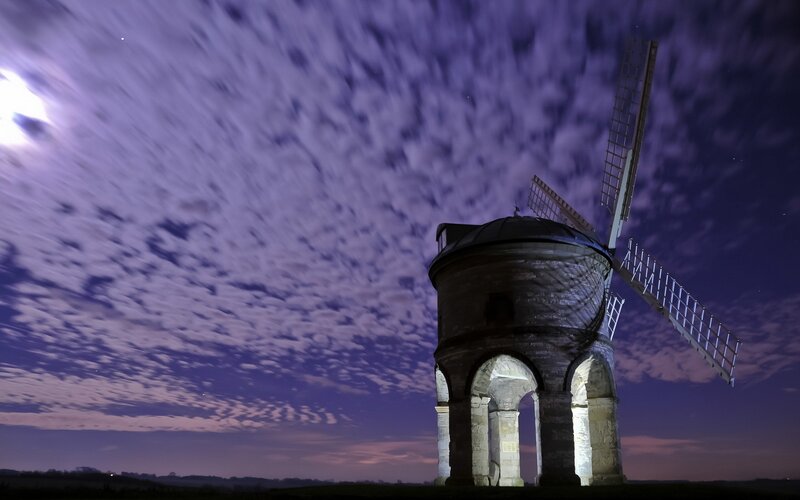 Windmill under moonlit sky
