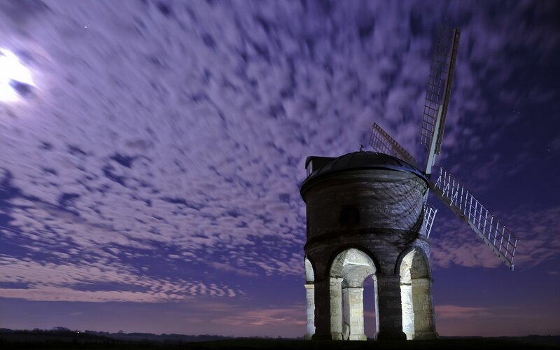 Windmill under moonlit sky