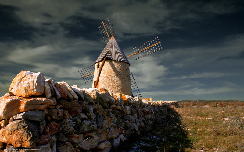 Windmill under stormy sky