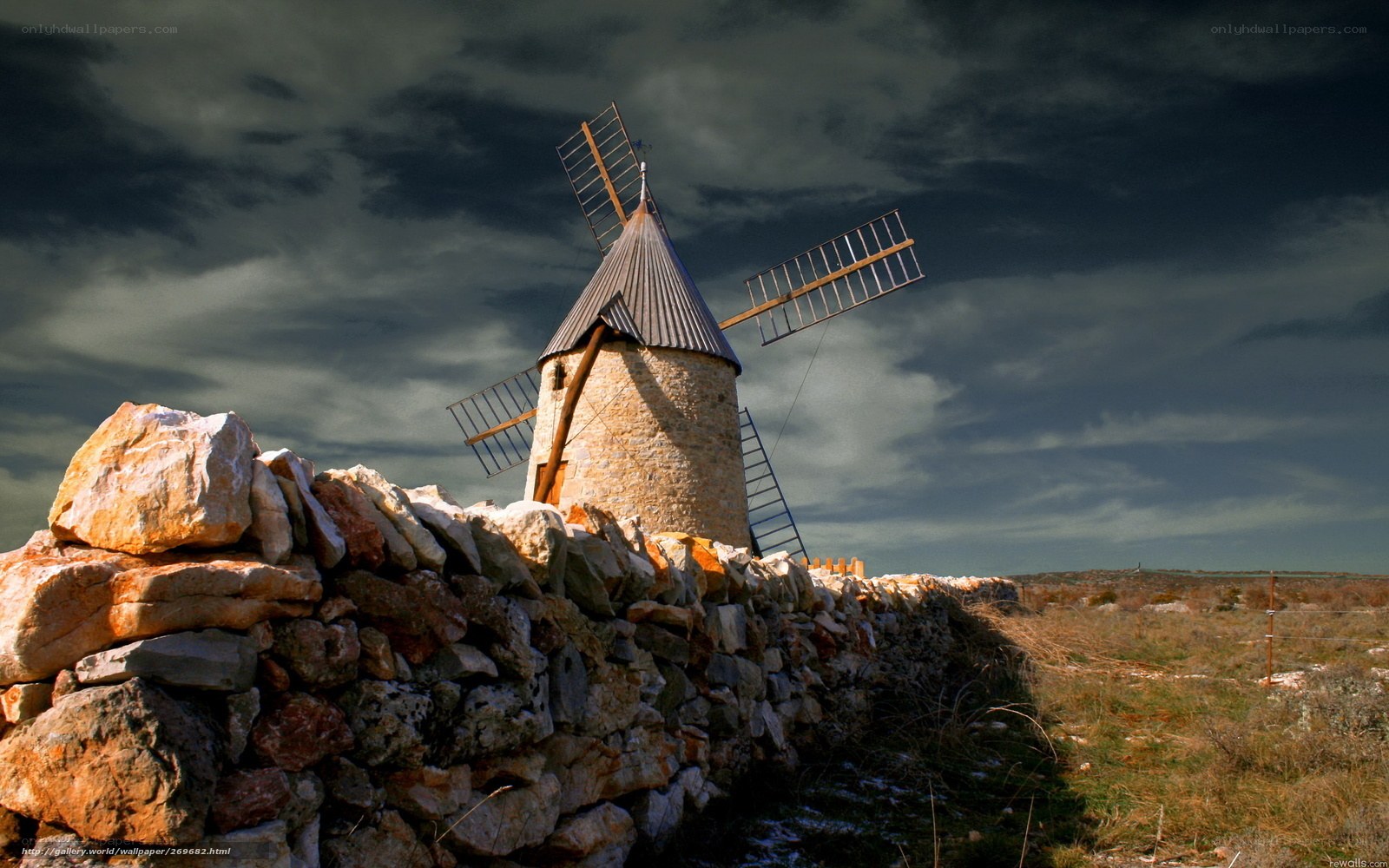 Windmill under stormy sky
