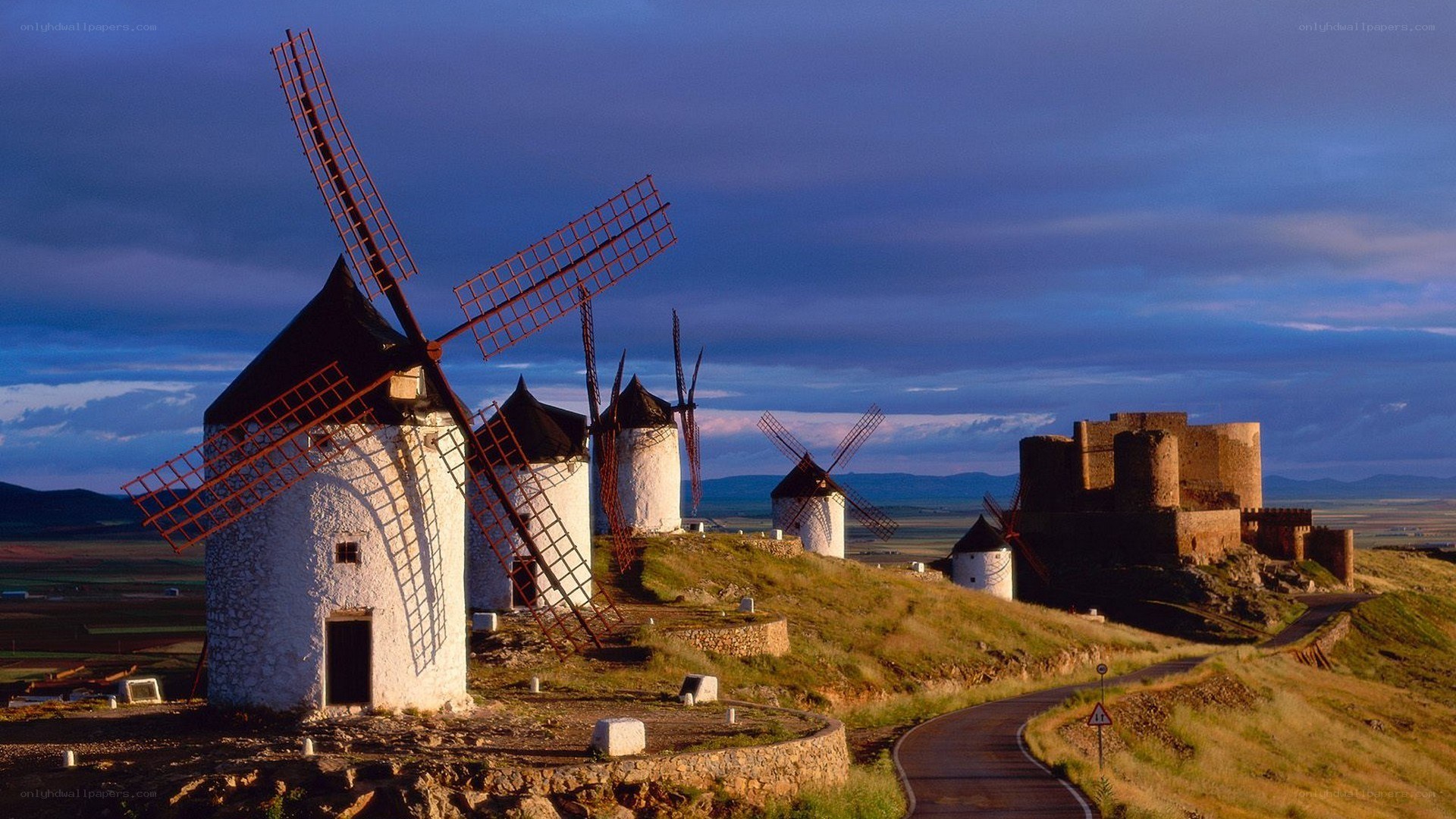 windmills and castle at dusk
