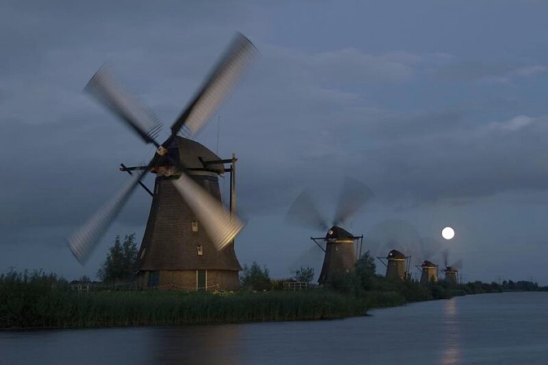 Windmills at dusk with moon