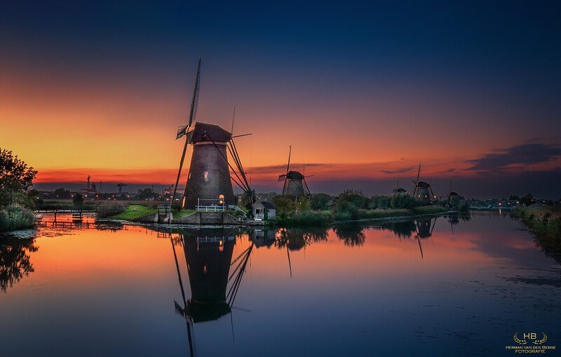 Windmills at Sunset — Orange, Serene, Photograph, River, Sky, Trees