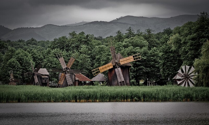 Windmills by a lake