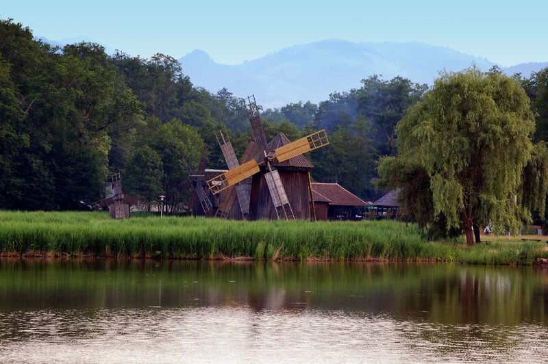 Windmills by a lake