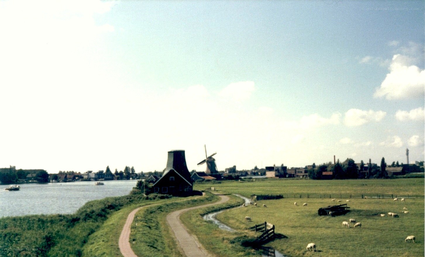 Windmills by a river in the Netherlands
