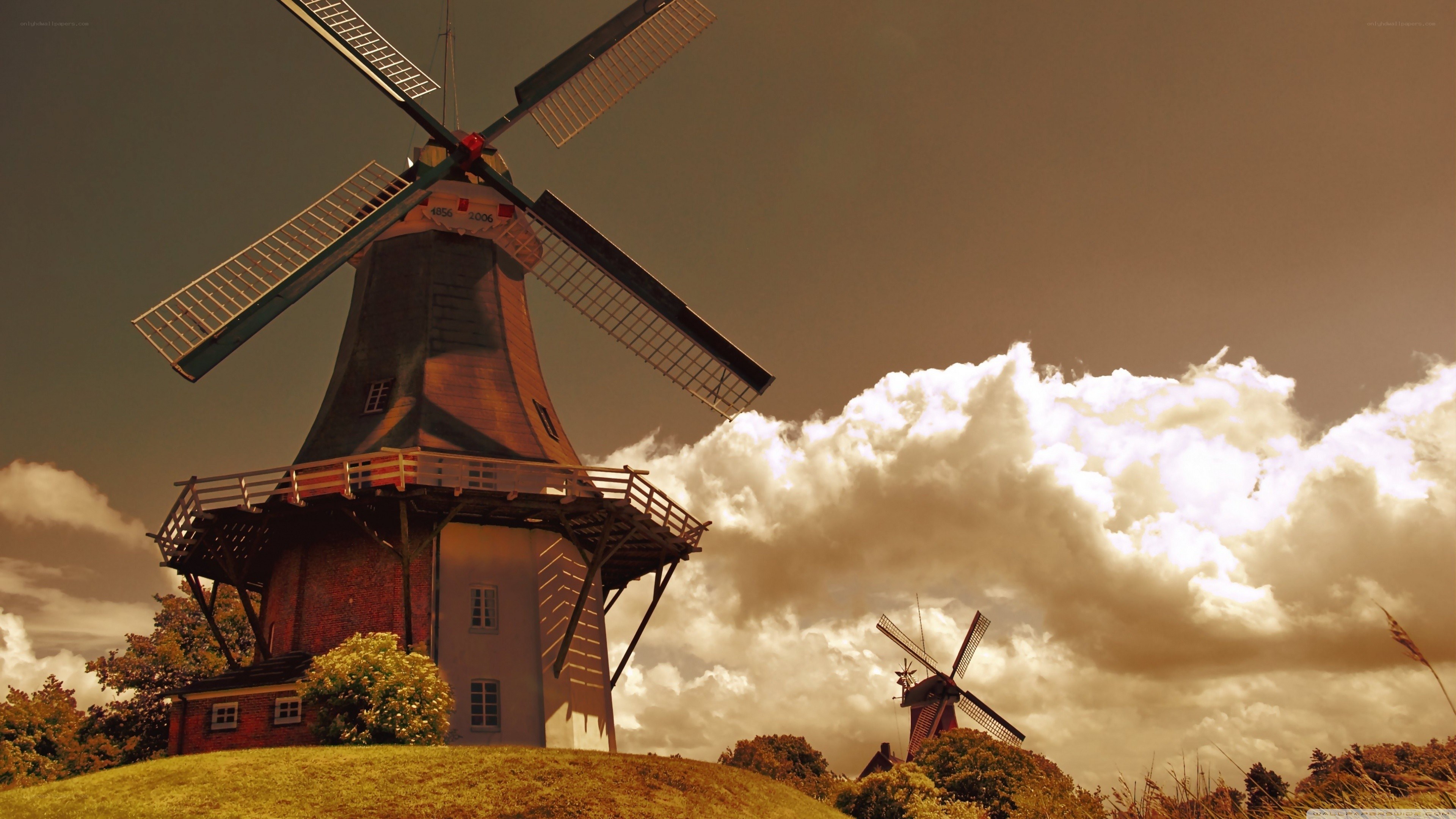 Windmills on a hill at sunset