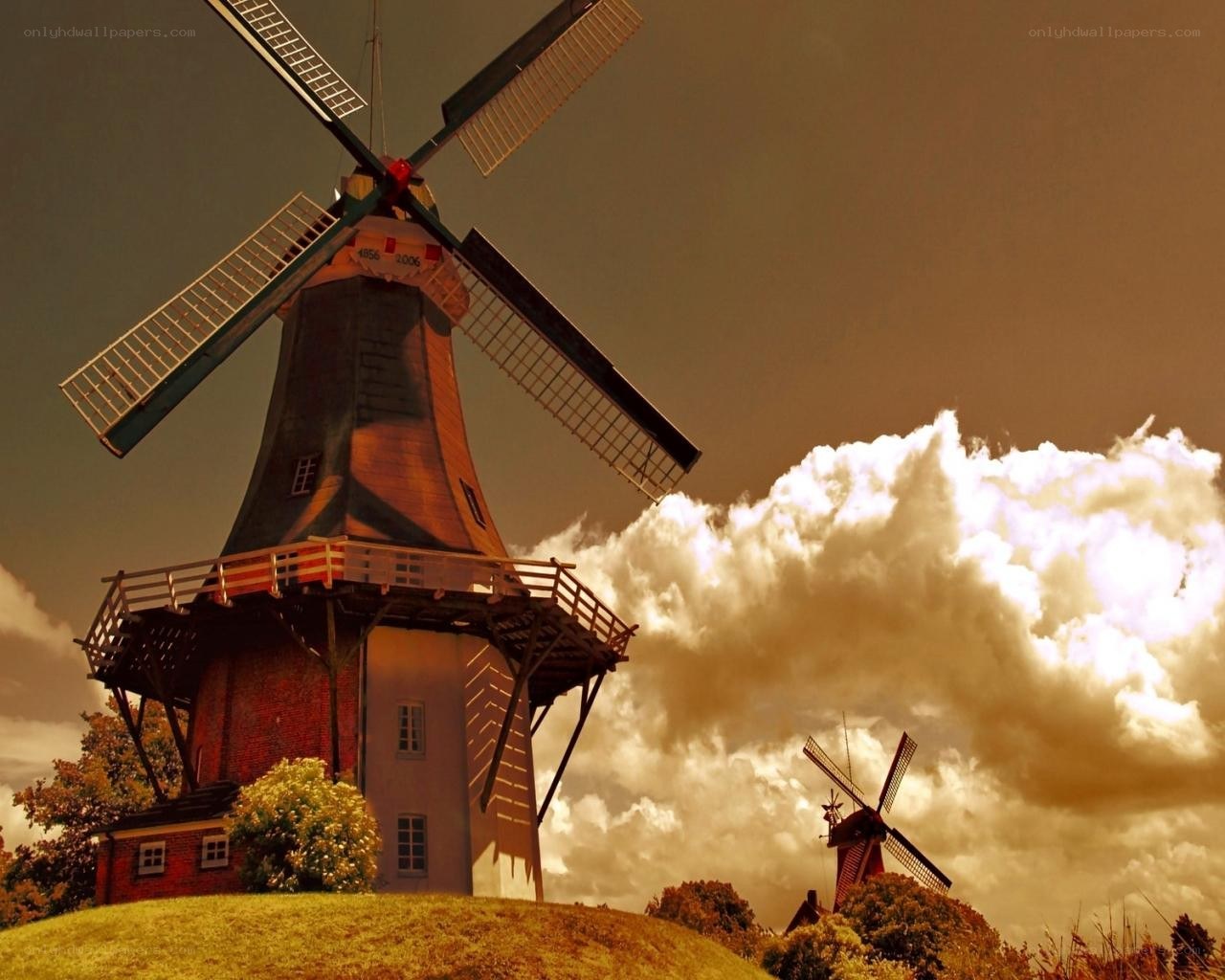 Windmills on a hill at sunset