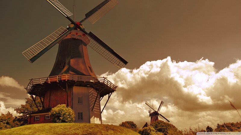 Windmills under cloudy sky