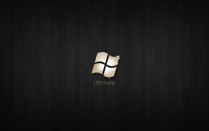 Windows Ultimate logo on dark wood