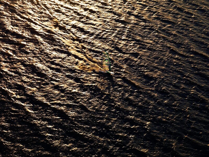 Windsurfer on sunlit water