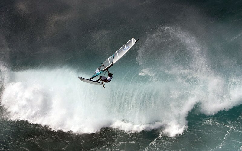 Windsurfer riding a large wave