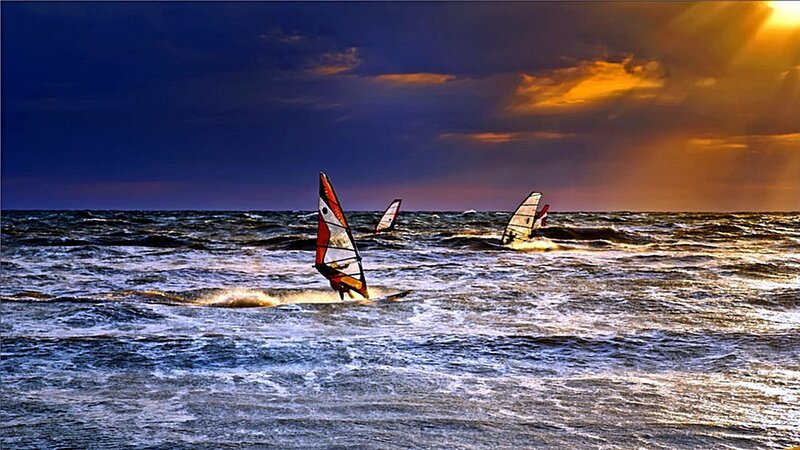 Windsurfers at sunset
