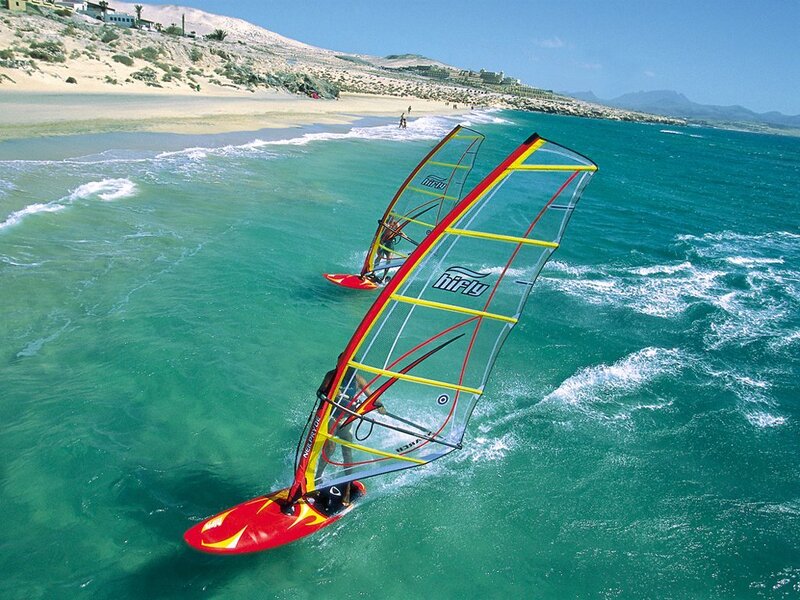 Windsurfers on a sunny beach