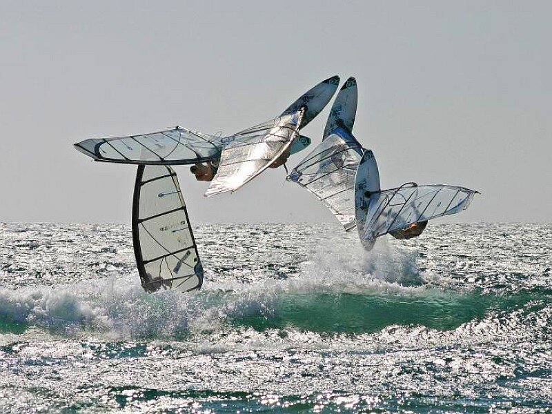 Windsurfers performing aerial tricks