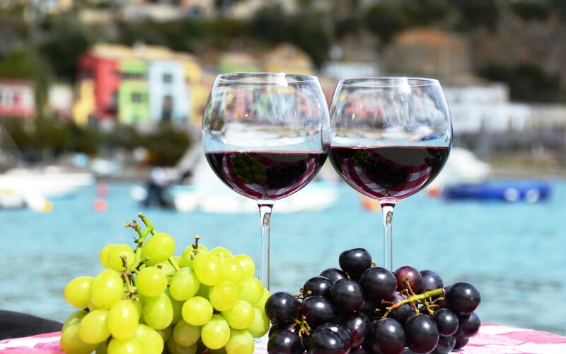 Wine and grapes by the water