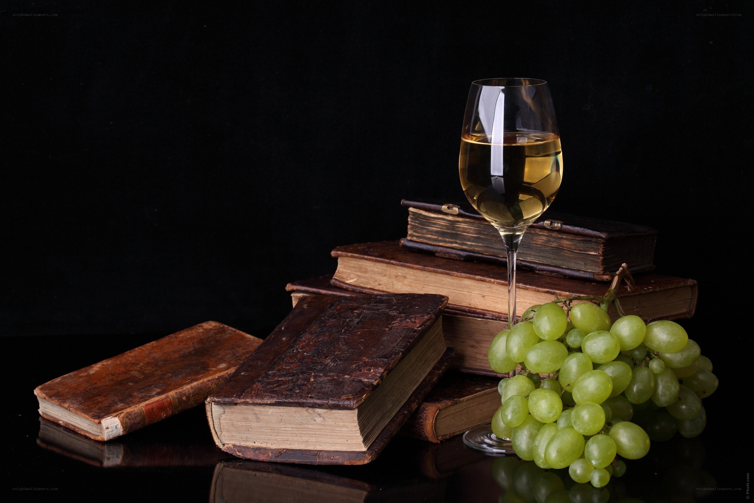 wine and grapes on books
