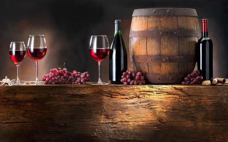 Wine and grapes on wooden table