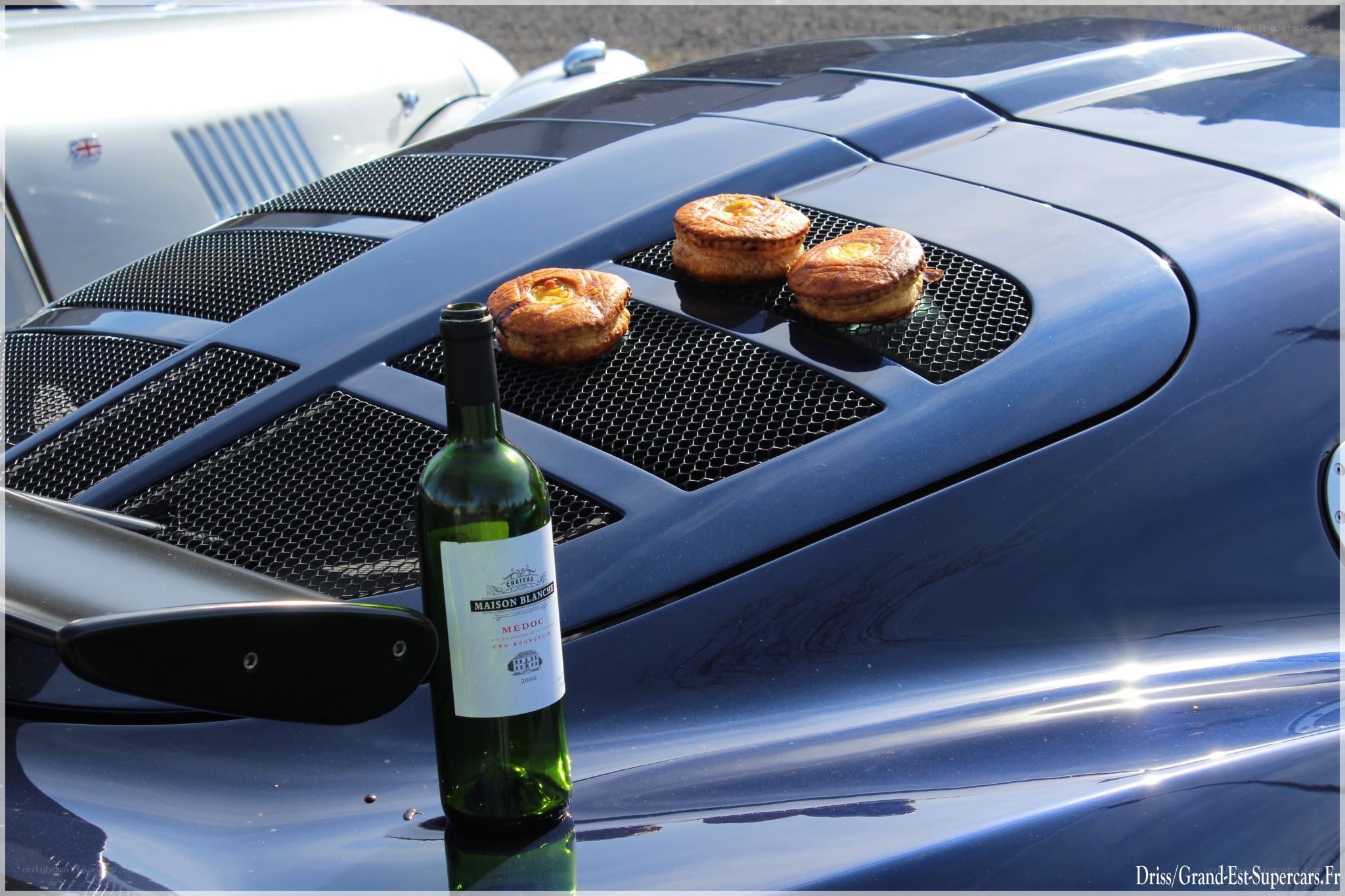 Wine and pastries on a car