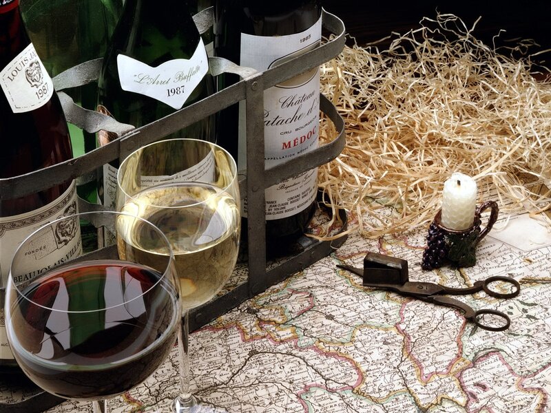 Wine bottles and glasses on map