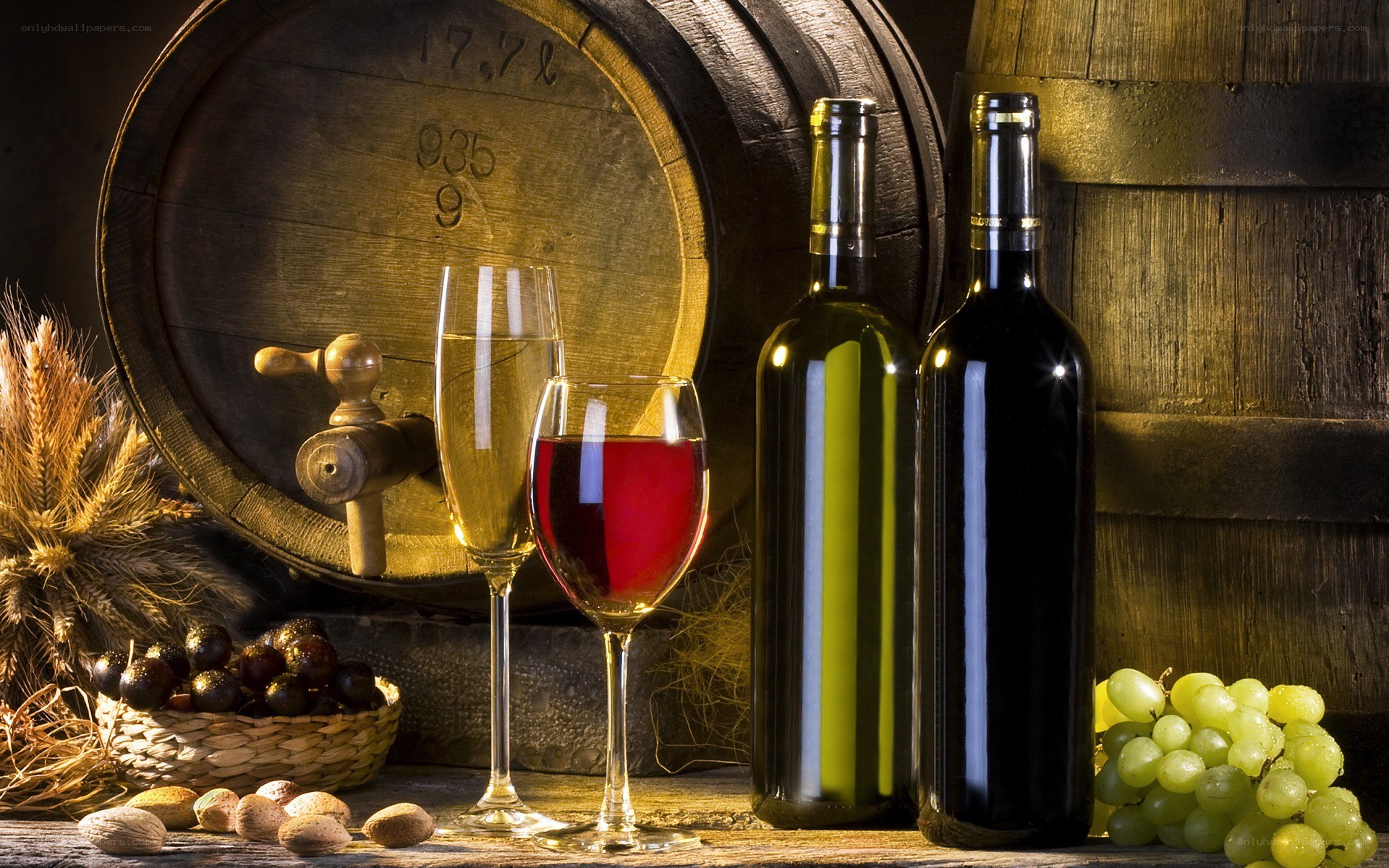 Wine bottles and grapes on table