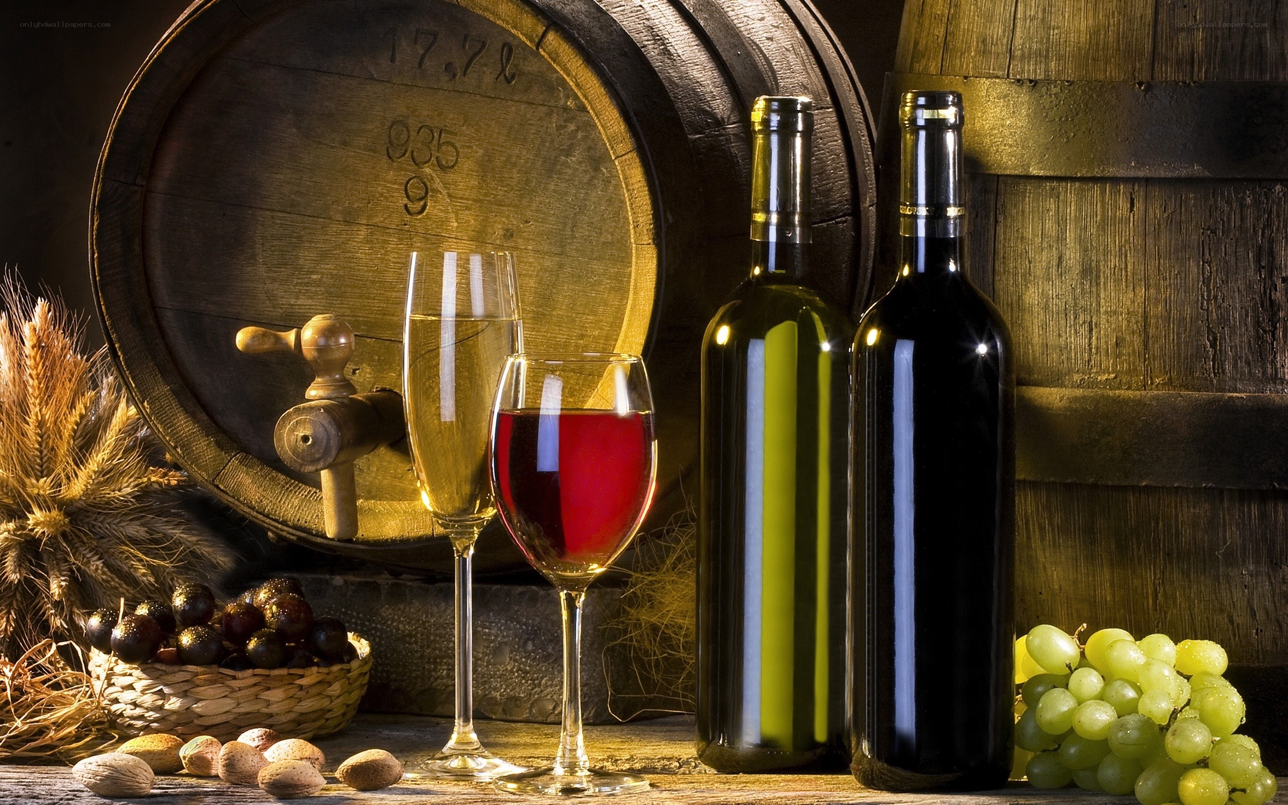 Wine bottles and grapes on table