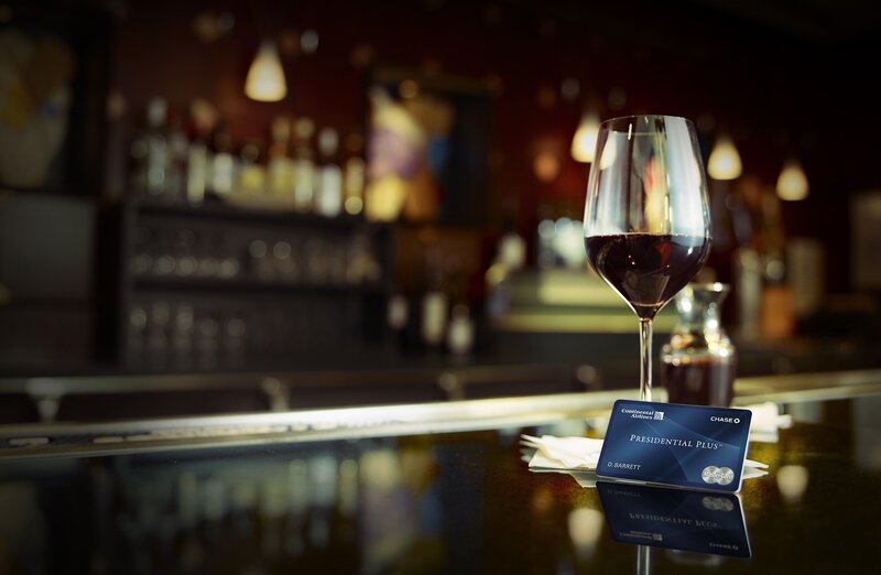 Wine glass and credit card on bar