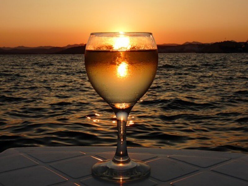 wine glass at sunset over water