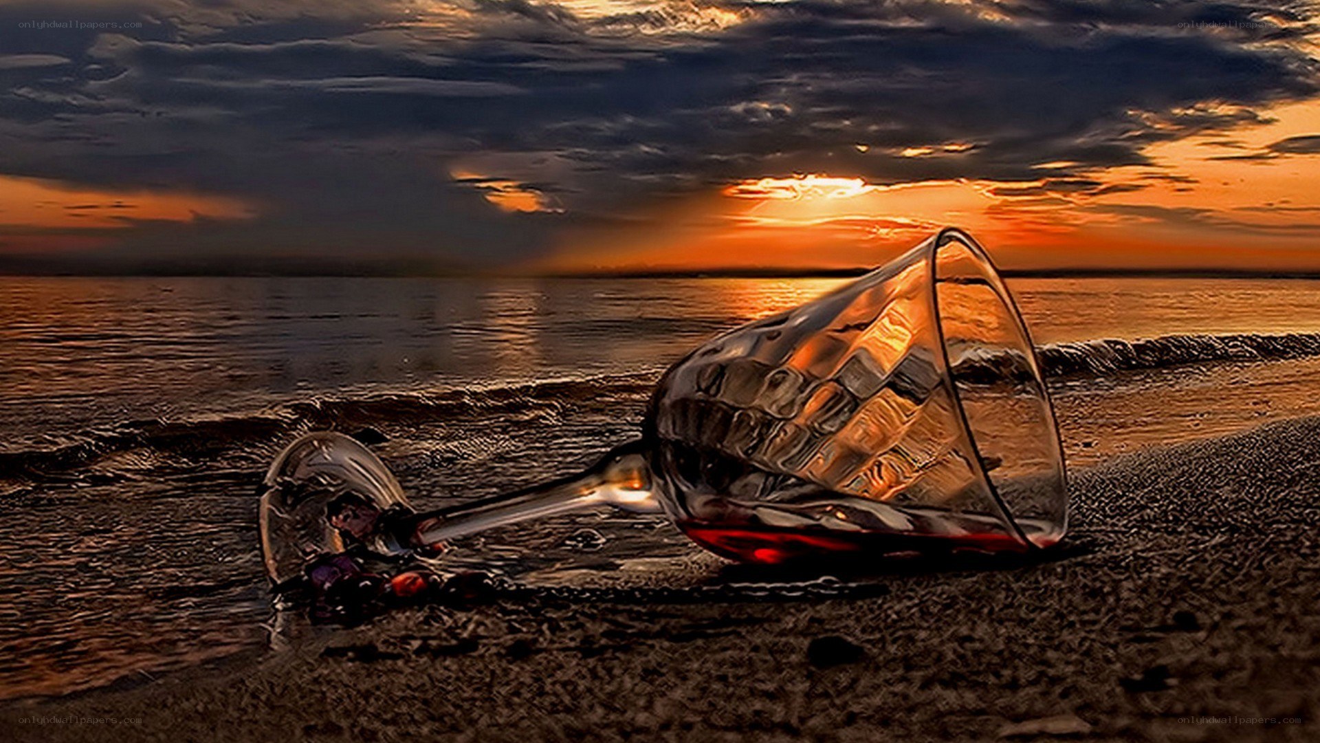 wine glass on beach at sunset