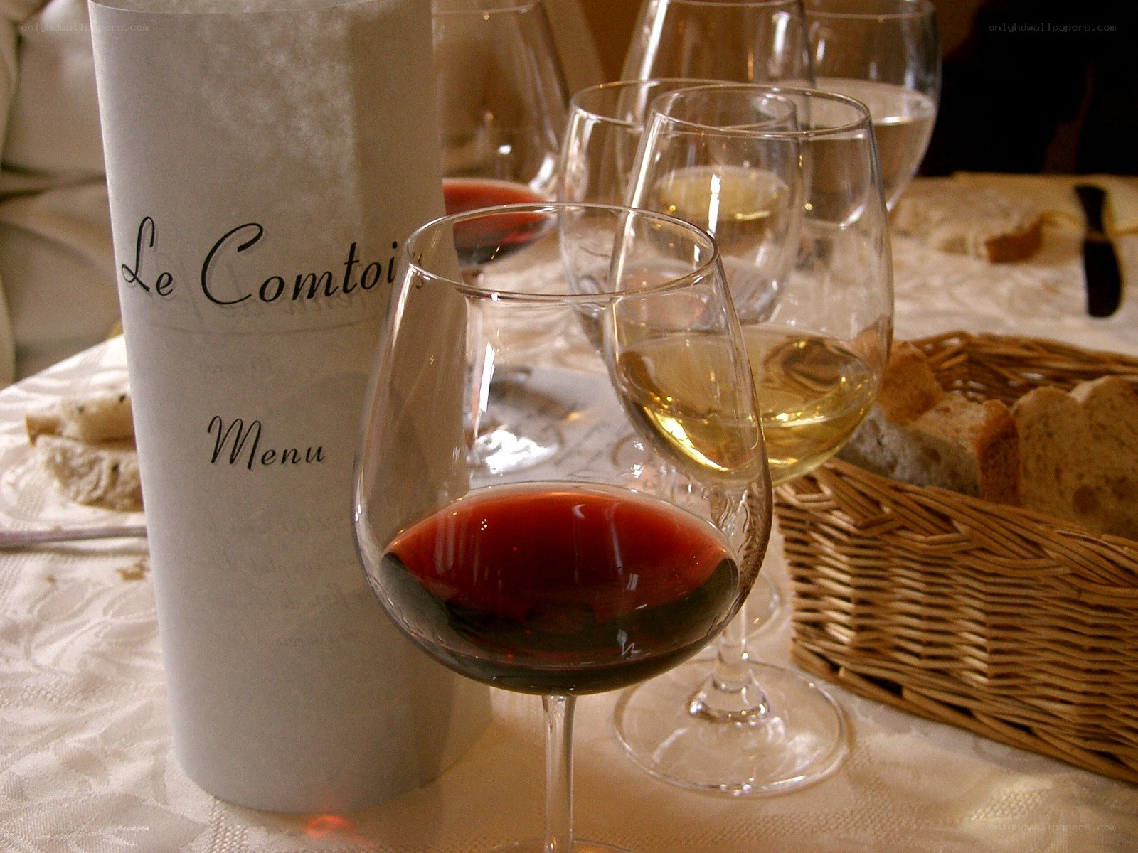 Wine glasses and menu on table