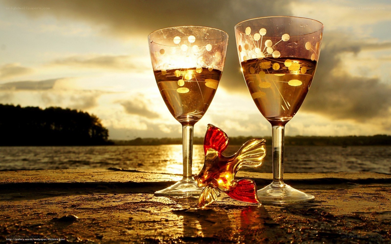 Wine glasses at sunset by water