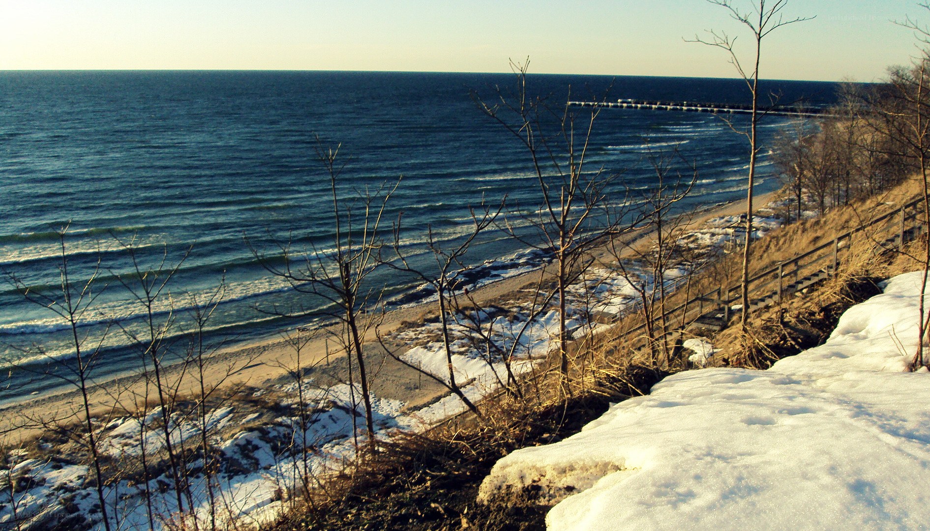 Winter beach with snow and ocean