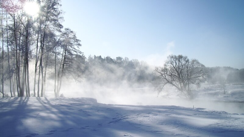 Winter mist over a snowy river