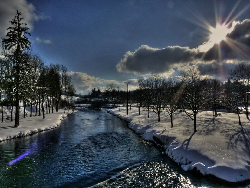 Winter river under sunburst