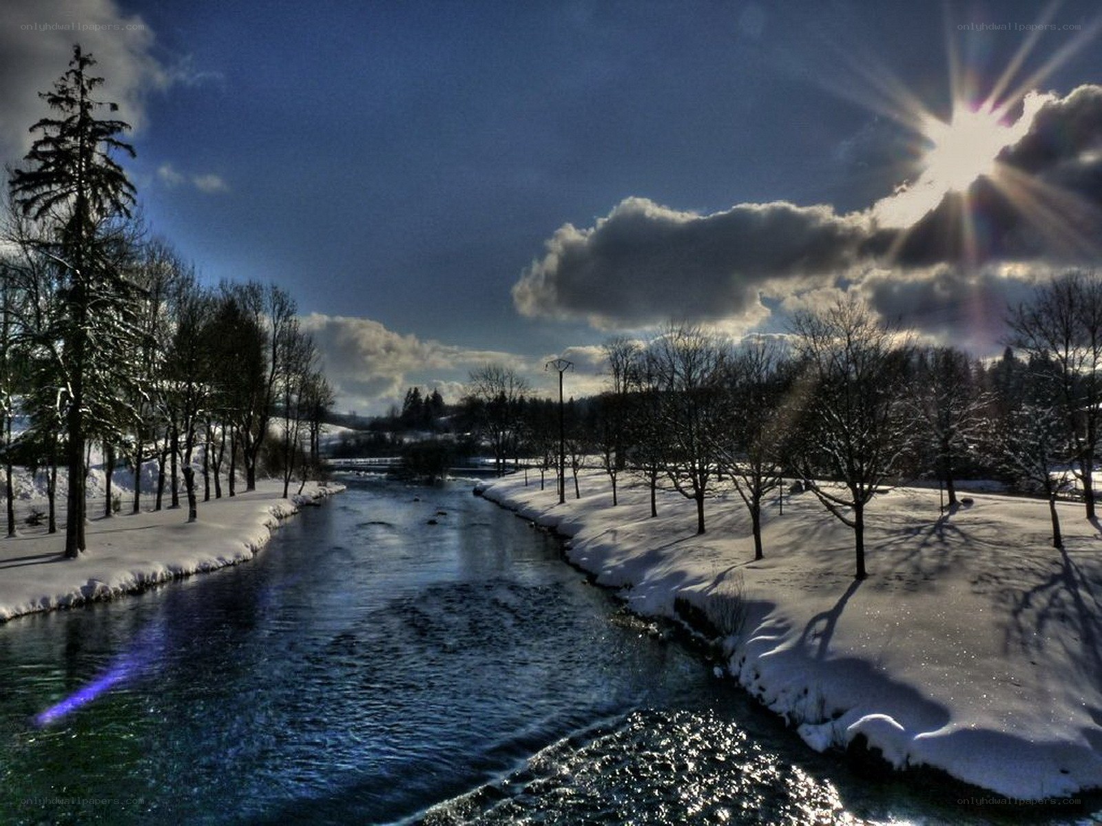 Winter river under sunburst