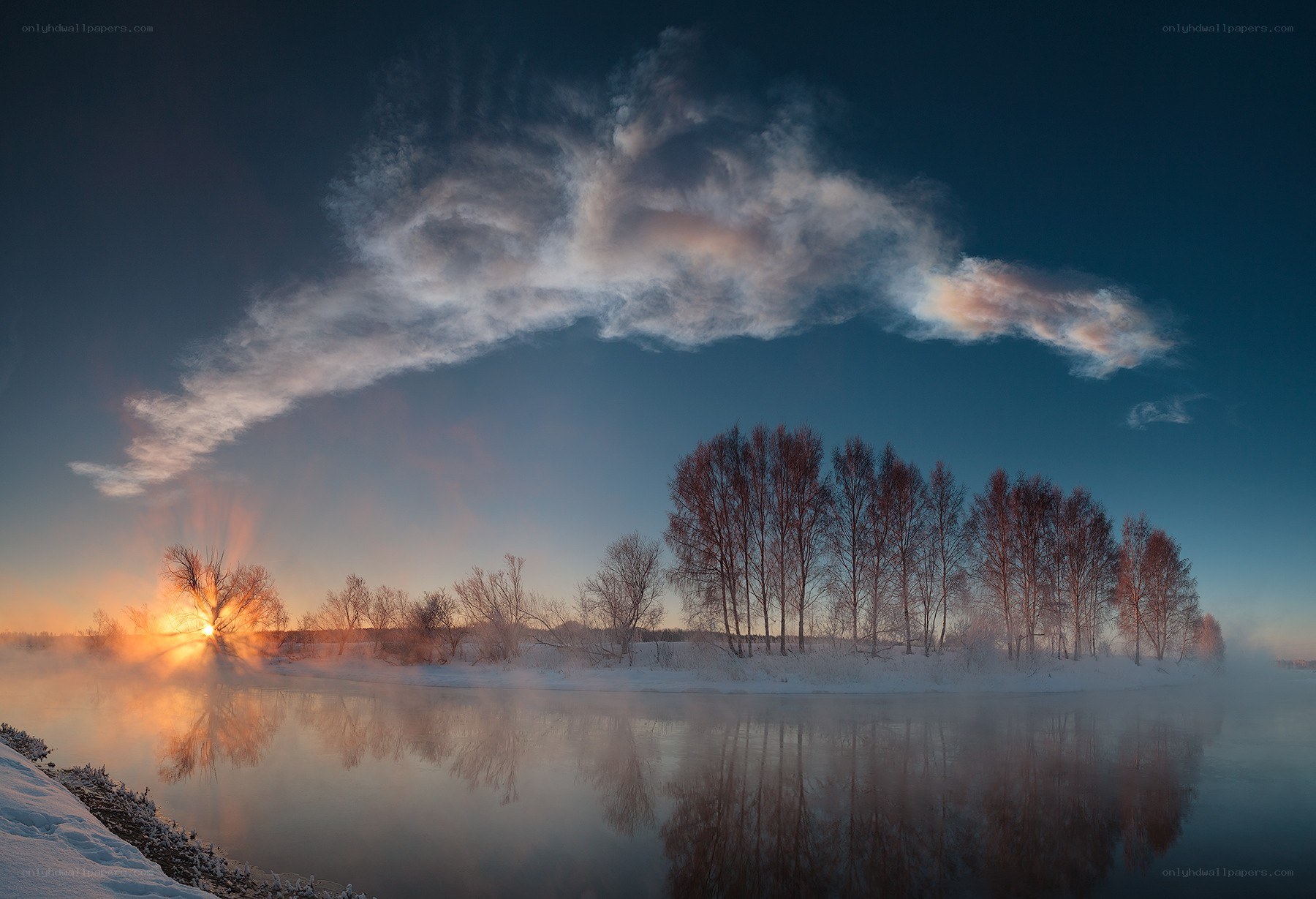 Winter sunrise over a misty river