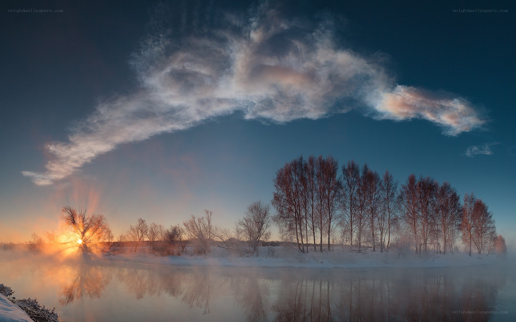 Winter sunrise over a misty river