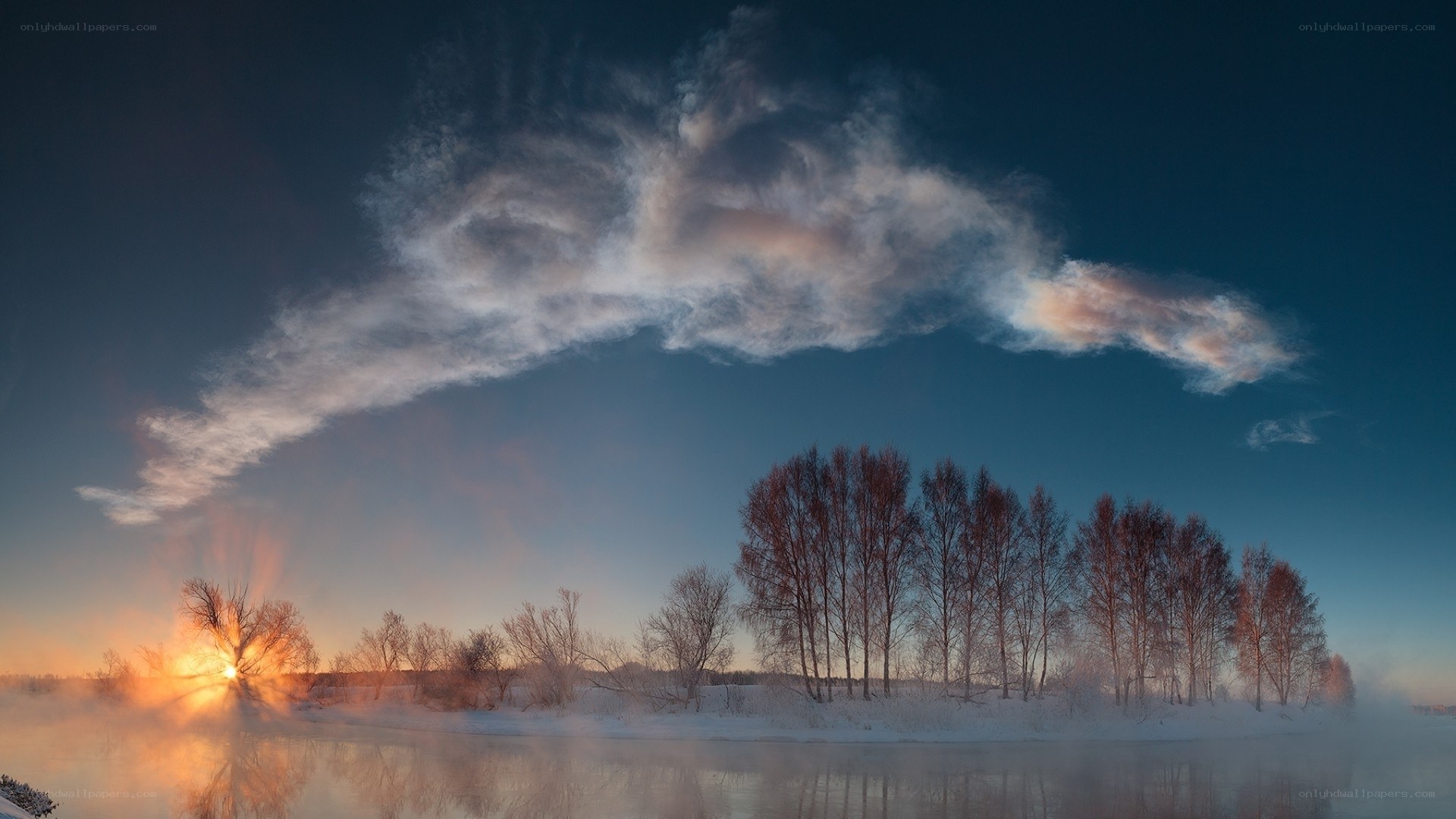 Winter sunrise over a misty river