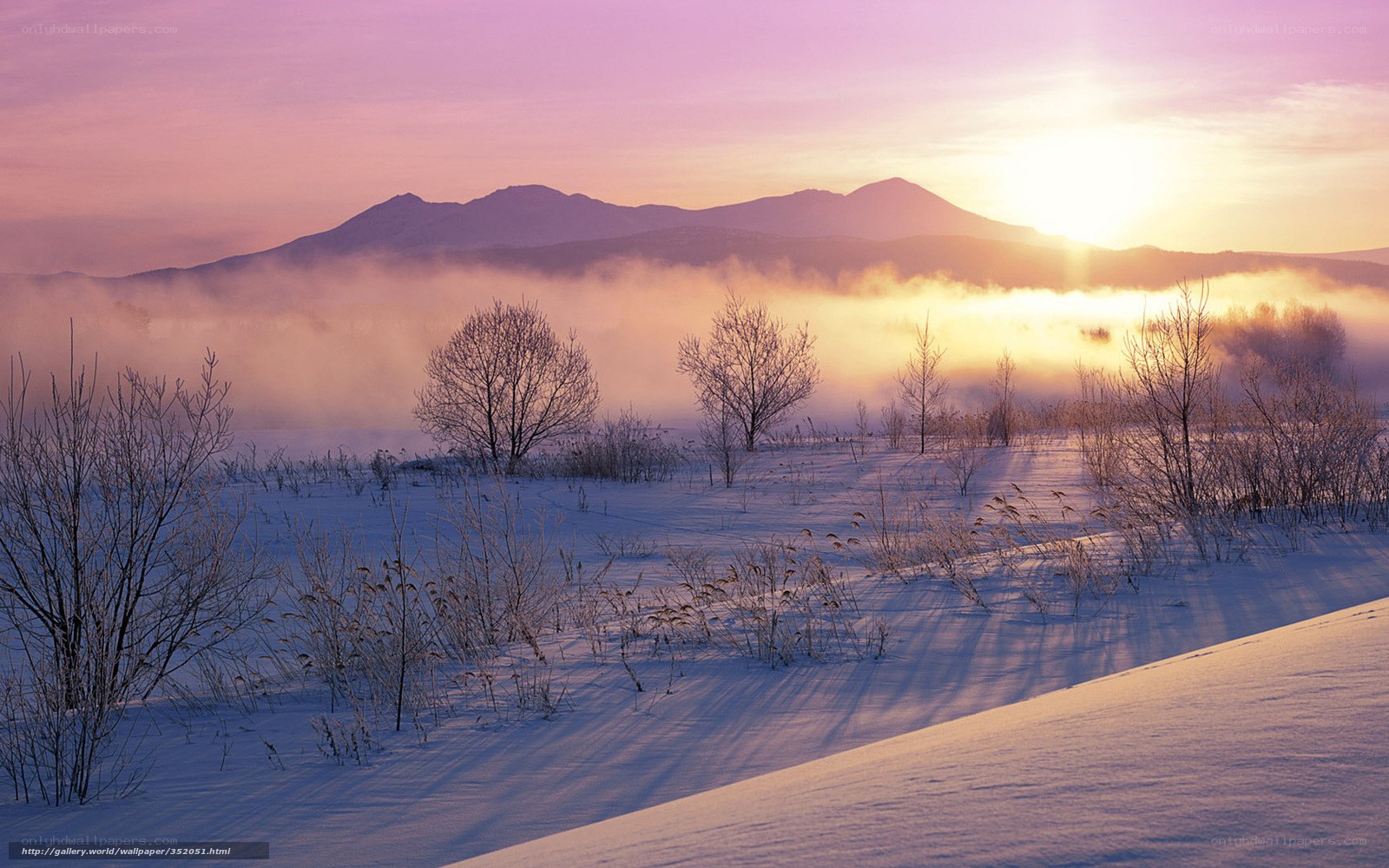Winter sunrise over snowy mountains