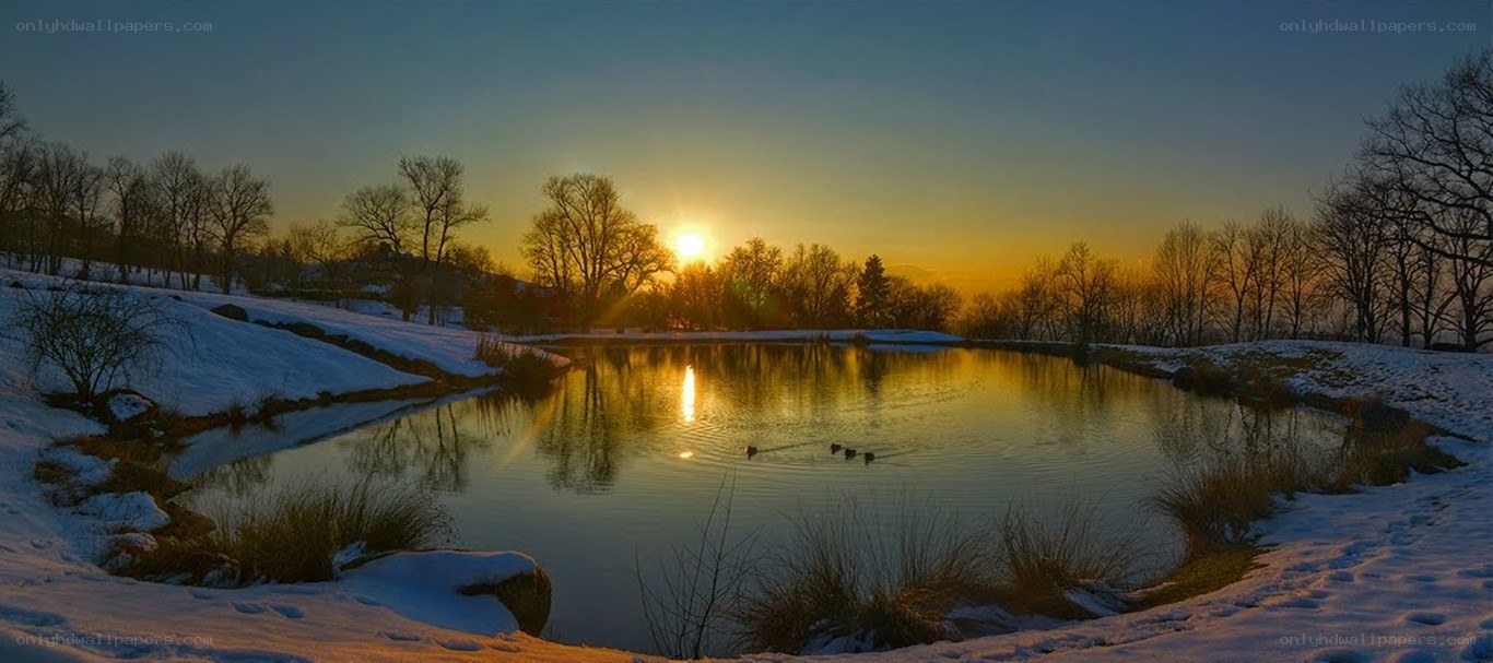Winter sunset at a snowy pond