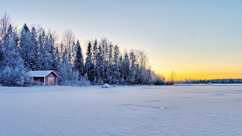 Winter sunset by a cabin