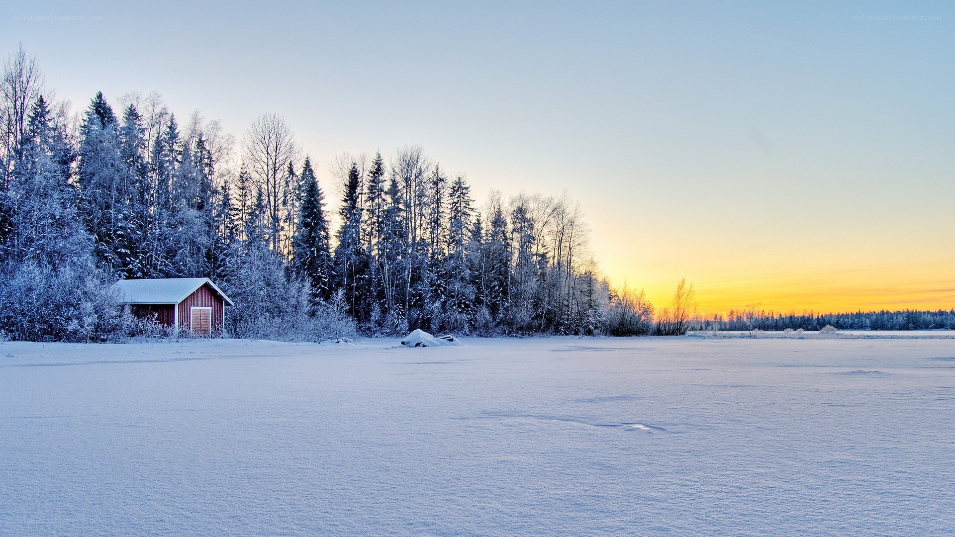 Winter sunset by a cabin