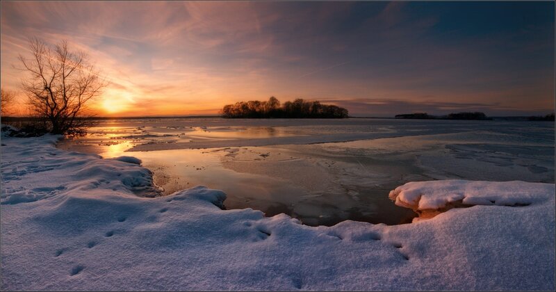 Winter sunset over a frozen lake
