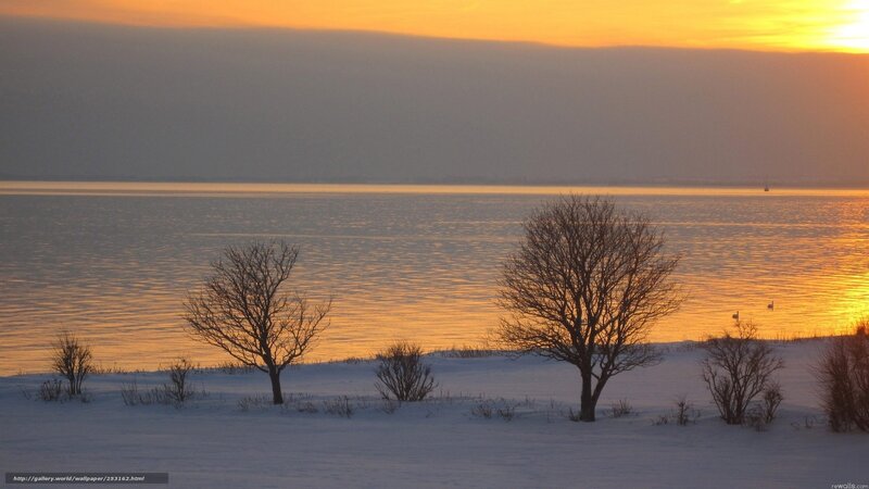 Winter sunset over a frozen lake