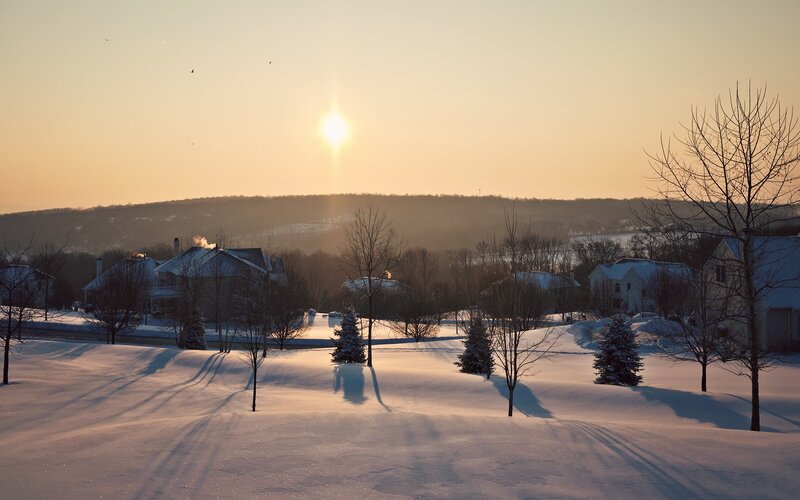 Winter sunset over a snowy neighborhood