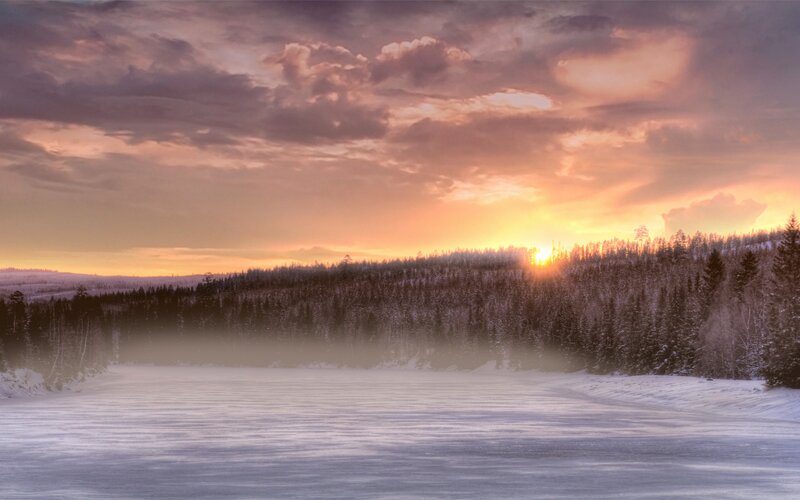 Winter sunset over frozen lake