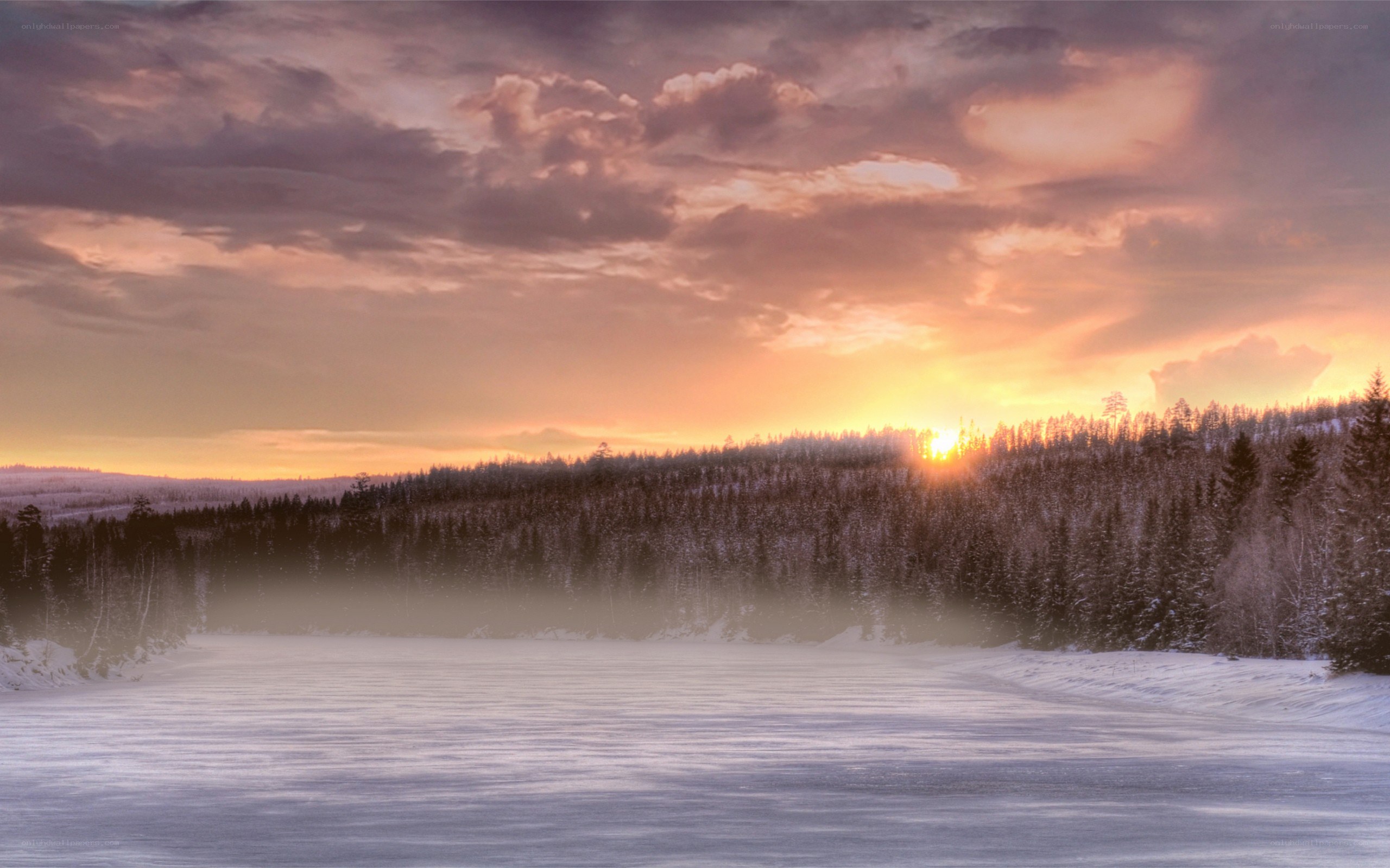 Winter sunset over frozen lake