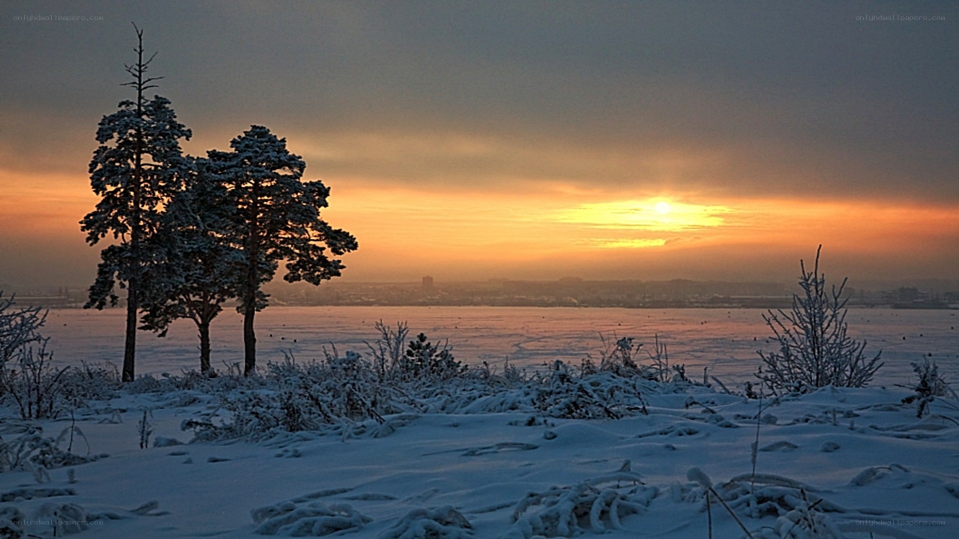 Winter sunset over frozen lake