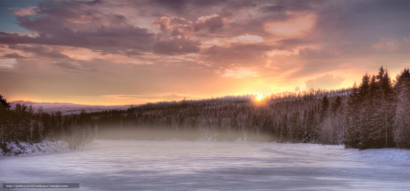 Winter sunset over frozen lake